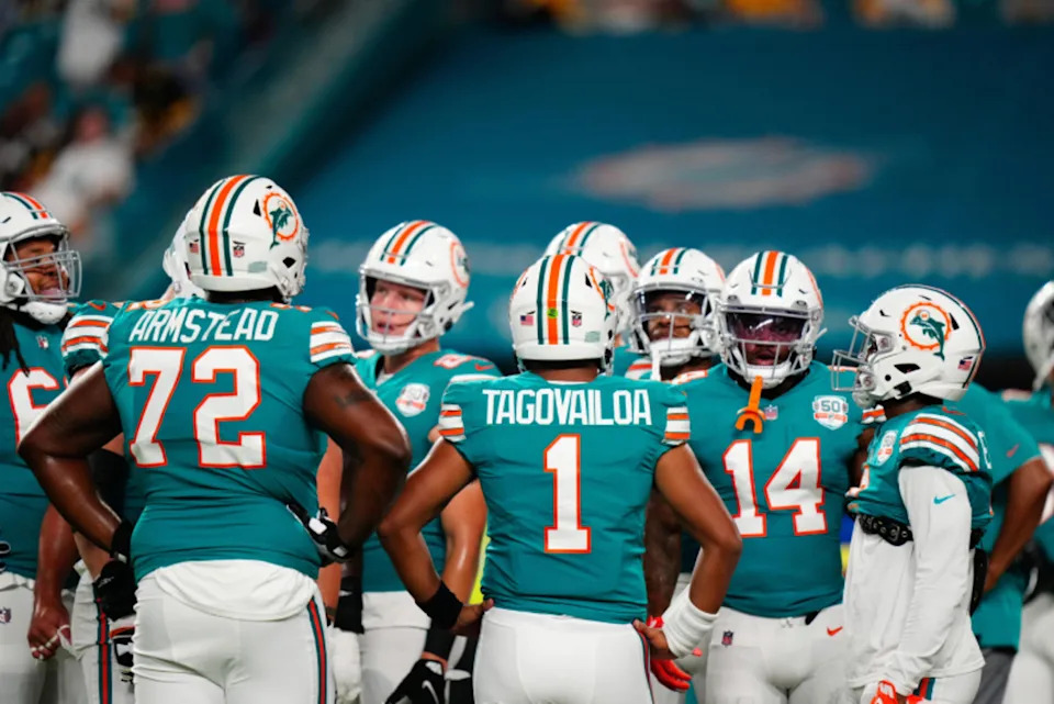 Miami Dolphins offensive tackle Terron Armstead (72) and Miami Dolphins quarterback Tua Tagovailoa (1) talk to teammates prior to a game against the Pittsburgh Steelers at Hard Rock Stadium.© Rich Storry-USA TODAY Sports