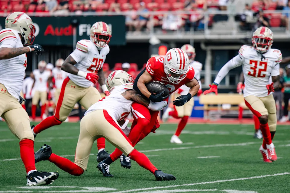 DC Defenders wide receiver Chris Rowland (12) is tackled by Birmingham Stallions cornerback Mario Goodrich (16) in the first quarter at Audi Field.© Emily Faith Morgan-Imagn Images
