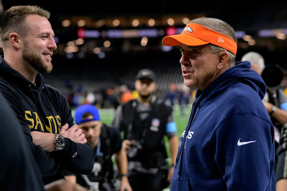 New Orleans Saints tight end Taysom Hill (7) talks to his former coach Denver Broncos head coach Sean Payton at Caesars Superdome.Matthew Hinton-Imagn Images