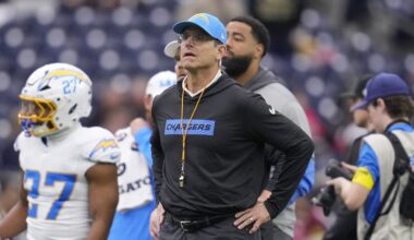 Los Angeles Chargers coach Jim Harbaugh watches players warm up before an NFL wild-card playoff football game against the Houston Texans, Jan. 11, 2025, in Houston. (AP Photo/Ashely Landis, File)