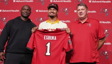 Tampa Bay Bucs first round draft pick Emeka Egbuka holds up a jersey with head coach Todd Bowles (right) and GM Jason Licht. Egbuka and the Bucs wrapped up their three-day mini camp on Thursday. (AP Photo/Chris O'Meara)