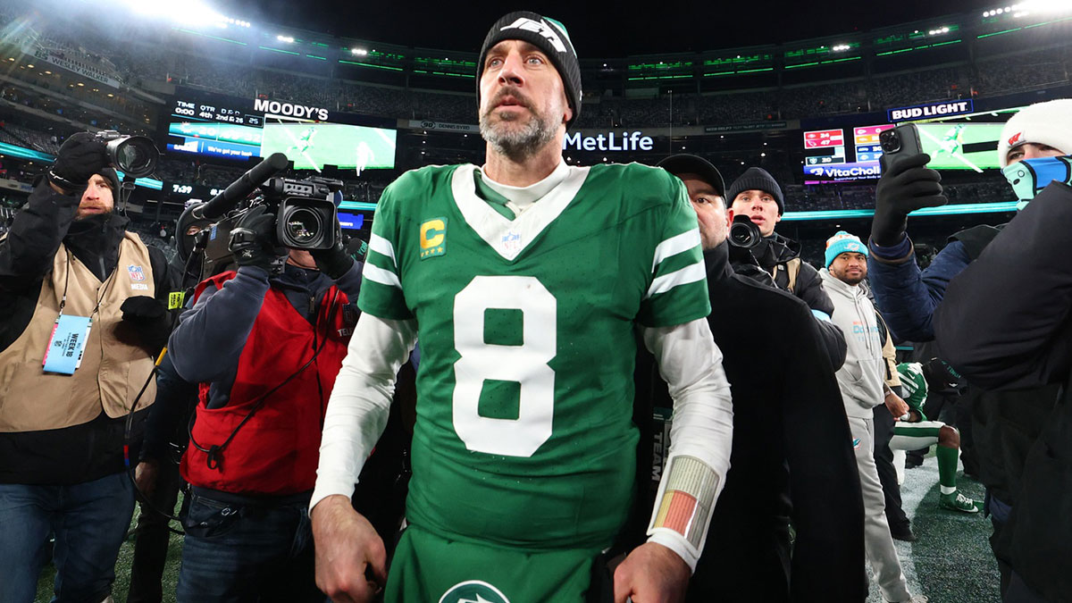 New York Jets quarterback Aaron Rodgers (8) walks on the field after the Jets win over the Miami Dolphins at MetLife Stadium.