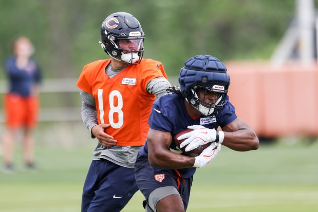 Bears quarterback Caleb Williams hands the ball off to running back Deion Hankins during practice at Halas Hall on Tuesday, June 3, 2025. (Eileen T. Meslar/Chicago Tribune)