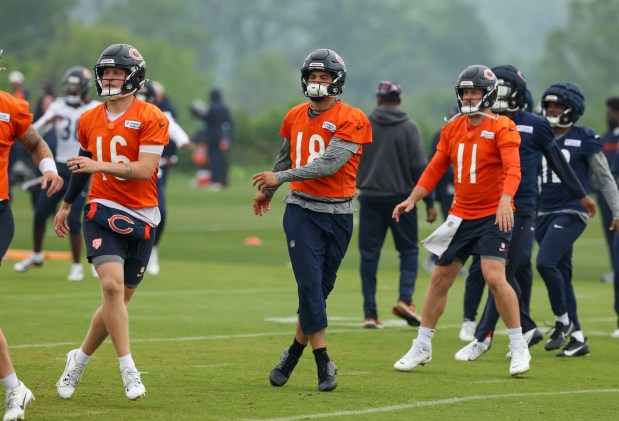 Quarterbacks Austin Reed (16), Caleb Williams (18) and Case Keenum stretch during Bears minicamp at Halas Hall on June 4, 2025, in Lake Forest. (Stacey Wescott/Chicago Tribune)
