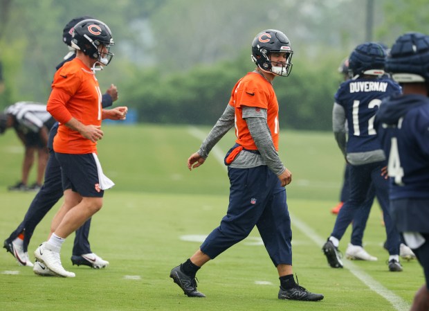 Quarterback Caleb Williams, right, walks down the field during Bears minicamp at Halas Hall on June 4, 2025, in Lake Forest. (Stacey Wescott/Chicago Tribune)