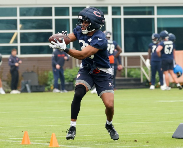 Running back Roschon Johnson catches the ball and turns upfield during Bears minicamp at Halas Hall on June 4, 2025, in Lake Forest. (Stacey Wescott/Chicago Tribune)