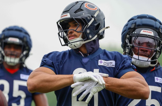 Running back Travis Homer fixes his gloves during Bears minicamp at Halas Hall on June 4, 2025, in Lake Forest. (Stacey Wescott/Chicago Tribune)