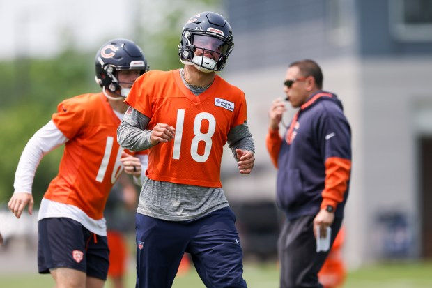 Chicago Bears quarterback Caleb Williams (18) and quarterback Austin Reed (16) warm up during practice at Halas Hall on Tuesday, June 10, 2025. (Eileen T. Meslar/Chicago Tribune)