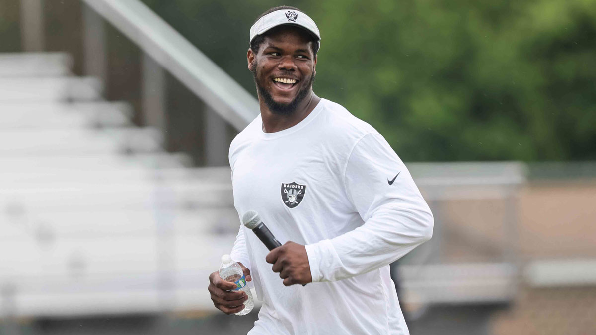 Las Vegas Raiders defensive tackle Bilal Nichols has a laugh during Nichols' BamFam Foundation football camp in the summer of 2021 at Hodgson Vo-Tech's football stadium in Glasgow.