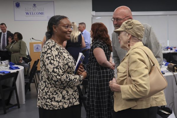El Camino College President Brenda Thames, left, speaks with family members of Athletics Hall of Fame inductees Beverly and Elizabeth Hazell, including former ECC wrestling coach Tom Hazell on Thursday, May 29. (Eddy Cermeno | The Union)