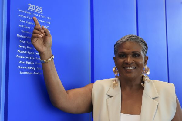 Toiya Barnes, El Camino College Athletic Hall of Fame inductee, points to her name on the 