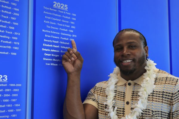 Brian Flowers, El Camino College athletic hall of fame inductee, points to his name on the 