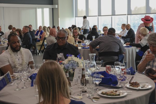 Attendees of the 2025 El Camino College Athletic Hall of Fame ceremony gather and celebrate as the event begins in the Gymnasium on Thursday, May 29. (Eddy Cermeno | The Union)