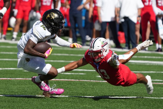 Colorado wide receiver LaJohntay Wester (10) makes the catch in front of Arizona defensive back Dalton Johnson in the first half during an NCAA college football game, Saturday, Oct. 19, 2024, in Tucson, Ariz. (AP Photo/Rick Scuteri)