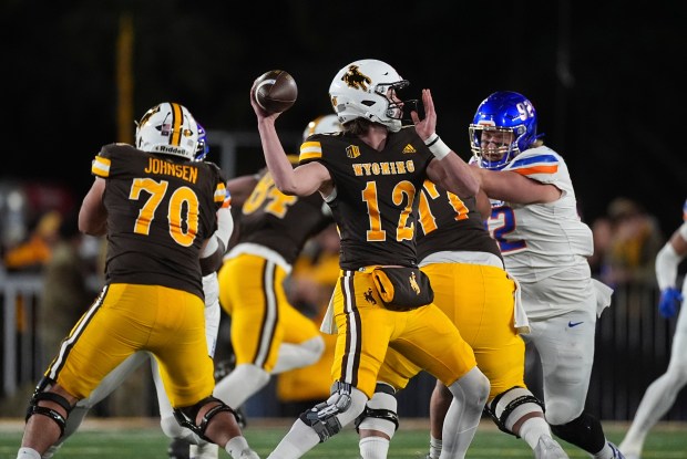 Wyoming quarterback Kaden Anderson (12) in the first half of an NCAA college football game Saturday, Nov. 23, 2024, in Laramie, Wyo. (AP Photo/David Zalubowski)
