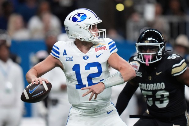 BYU quarterback Jake Retzlaff (12) looks to throw against Colorado during the first half of the Alamo Bowl NCAA college football game, Saturday, Dec. 28, 2024, in San Antonio. (AP Photo/Eric Gay)