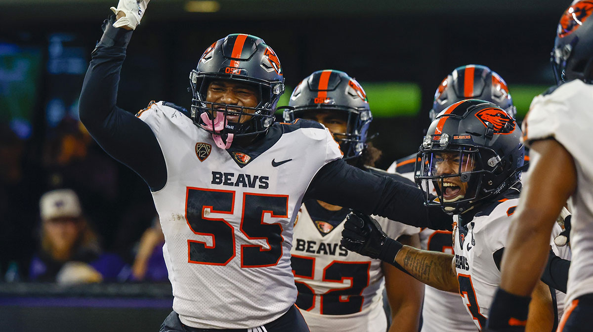 Oregon State Beavers linebacker Easton Mascarenas-Arnold (55) celebrates with defensive back Jaydon Grant (3) after returning an interception for a touchdown against the Washington Huskies during the second quarter at Alaska Airlines Field at Husky Stadium.