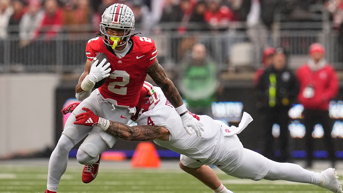 Ohio State Buckeyes wide receiver Emeka Egbuka (2) runs past Indiana Hoosiers linebacker Aiden Fisher (4) during the first half of the NCAA football game at Ohio Stadium in Columbus on Saturday, Nov. 23, 2024.