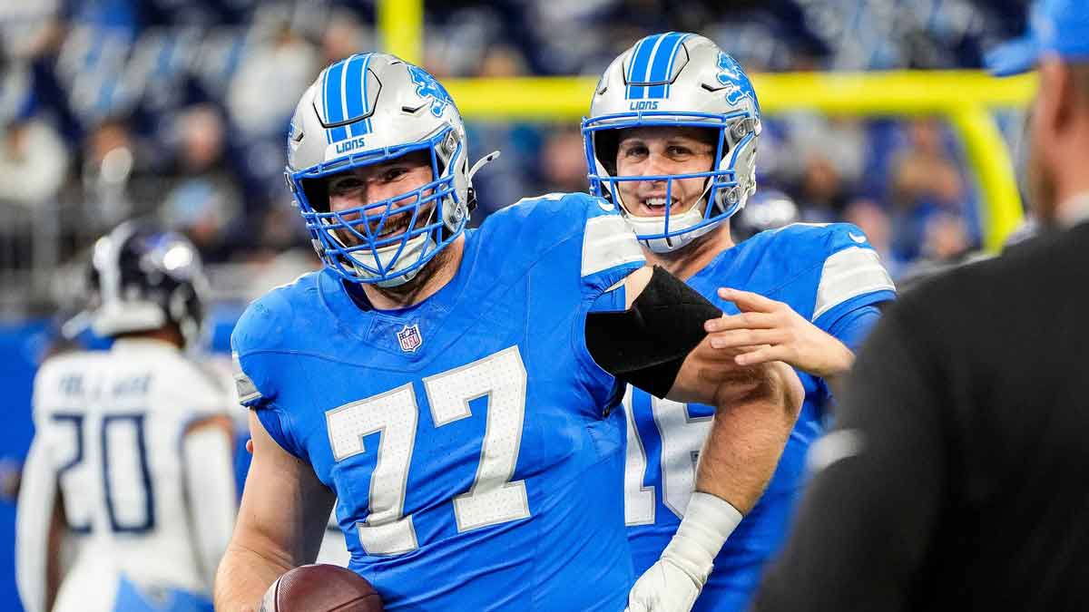 Detroit Lions quarterback Jared Goff (16) talks to center Frank Ragnow (77) during warm up before the Tennessee Titans game at Ford Field in Detroit on Sunday, Oct. 27, 2024.