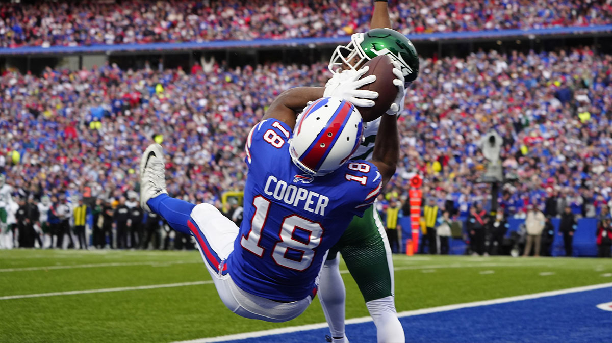 Buffalo Bills wide receiver Amari Cooper (18) makes a catch for a touchdown against New York Jets cornerback Brandin Echols (26) during the second half at Highmark Stadium.