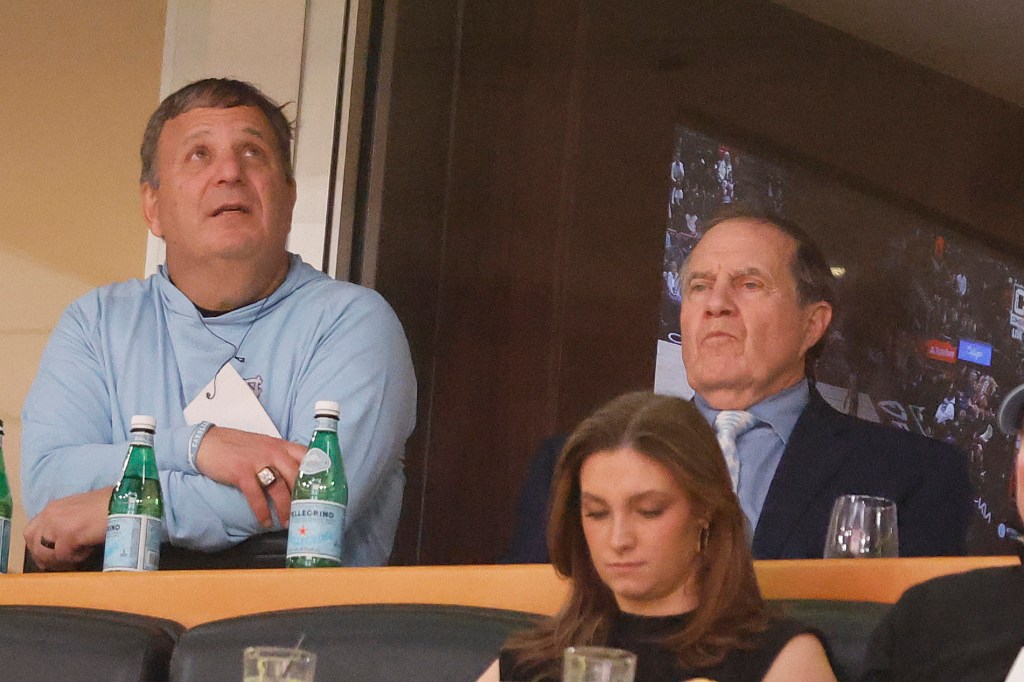Head football coach Bill Belichick of the North Carolina Tar Heels looks on with general manager Michael Lombardi during the second half between the Chicago Bulls and the Denver Nuggets at the United Center on January 27, 2025 in Chicago, Illinois. 