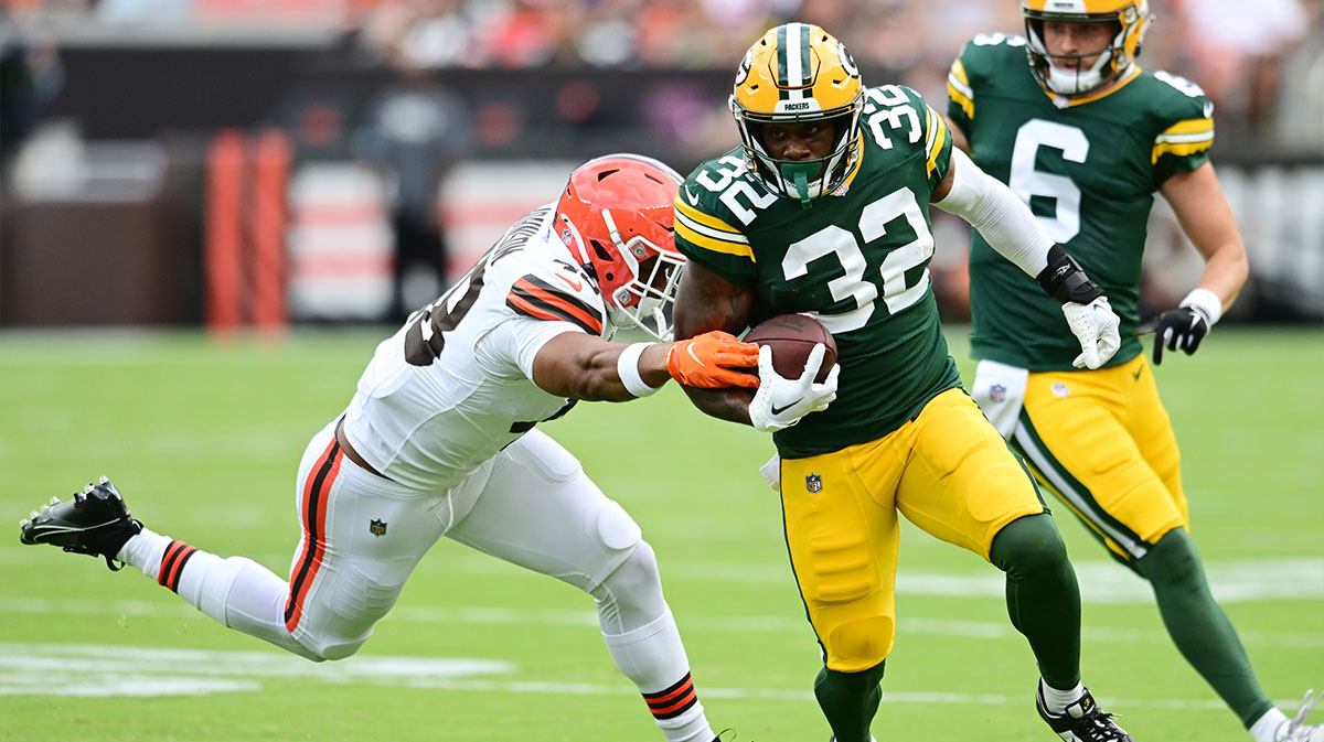 Green Bay Packers running back MarShawn Lloyd (32) runs with the ball as Cleveland Browns linebacker Caleb Johnson (48) defends during the second half at Cleveland Browns Stadium.