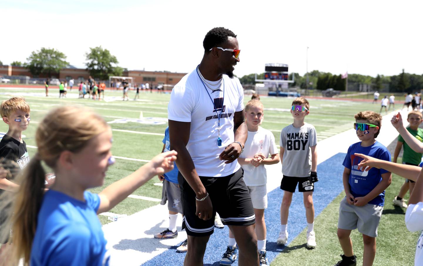 Former St. Charles North standout and current New York Giants defensive back Tyler Nubin works with young players on the first day of a three-day football camp on Friday, June 20, 2025 in St. Charles.