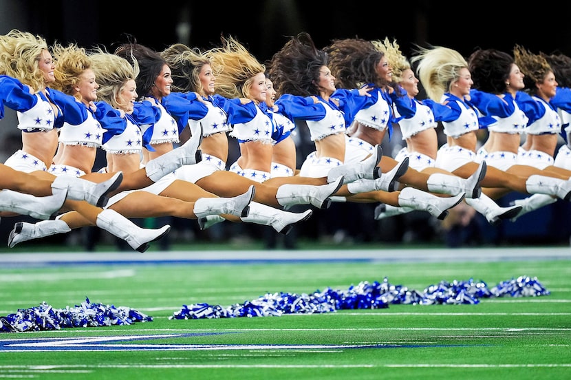 The Dallas Cowboys Cheerleaders performing jump splits.