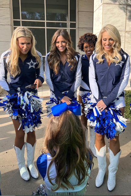 Junior DCC Angelina Crosby (with her back to camera) chats with cheerleaders from the Dallas...