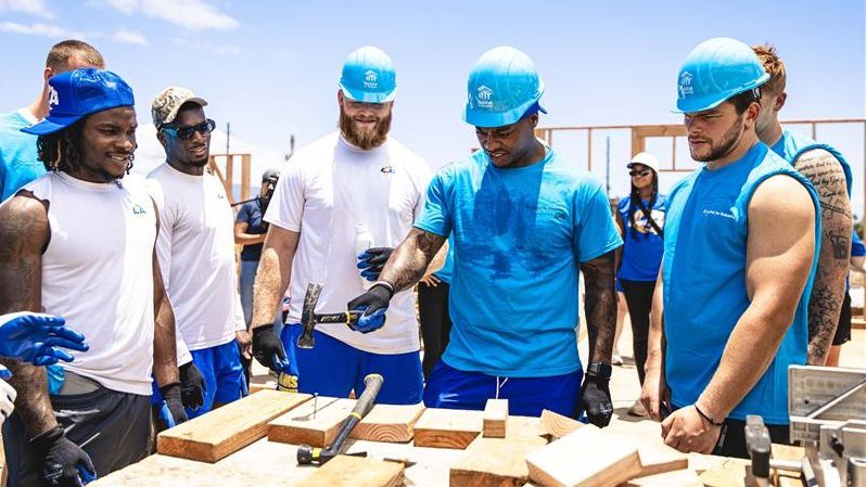 Los Angeles Rams rookies, including linebacker Chris Paul Jr., with hammer, worked on rebuilding a Lahaina home in a partnership with Habitat for Humanity Maui on Tuesday.