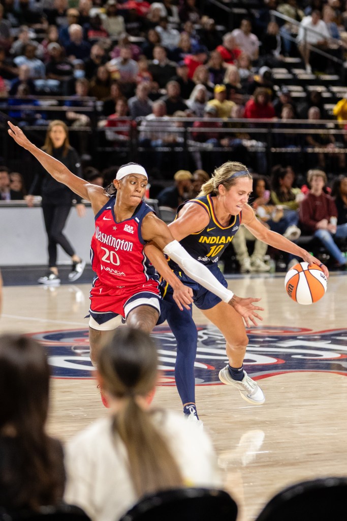 Washington Mystics guard Brittney Sykes (left) defends Indiana Fever guard Lexie Hull as she makes her way to the basket. (Marcus Relacion/The Washington Informer)
