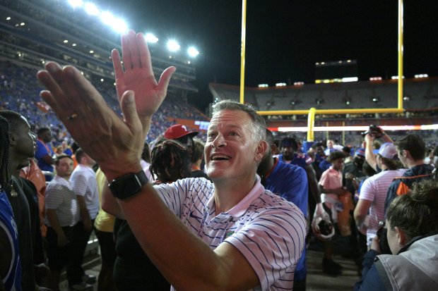 Florida athletic director Scott Stricklin acknowledges fans while walking to the locker room after the Gators' 26-21 win against Utah Sept. 3, 2022, in Gainesville. (AP Photo/Phelan M. Ebenhack)