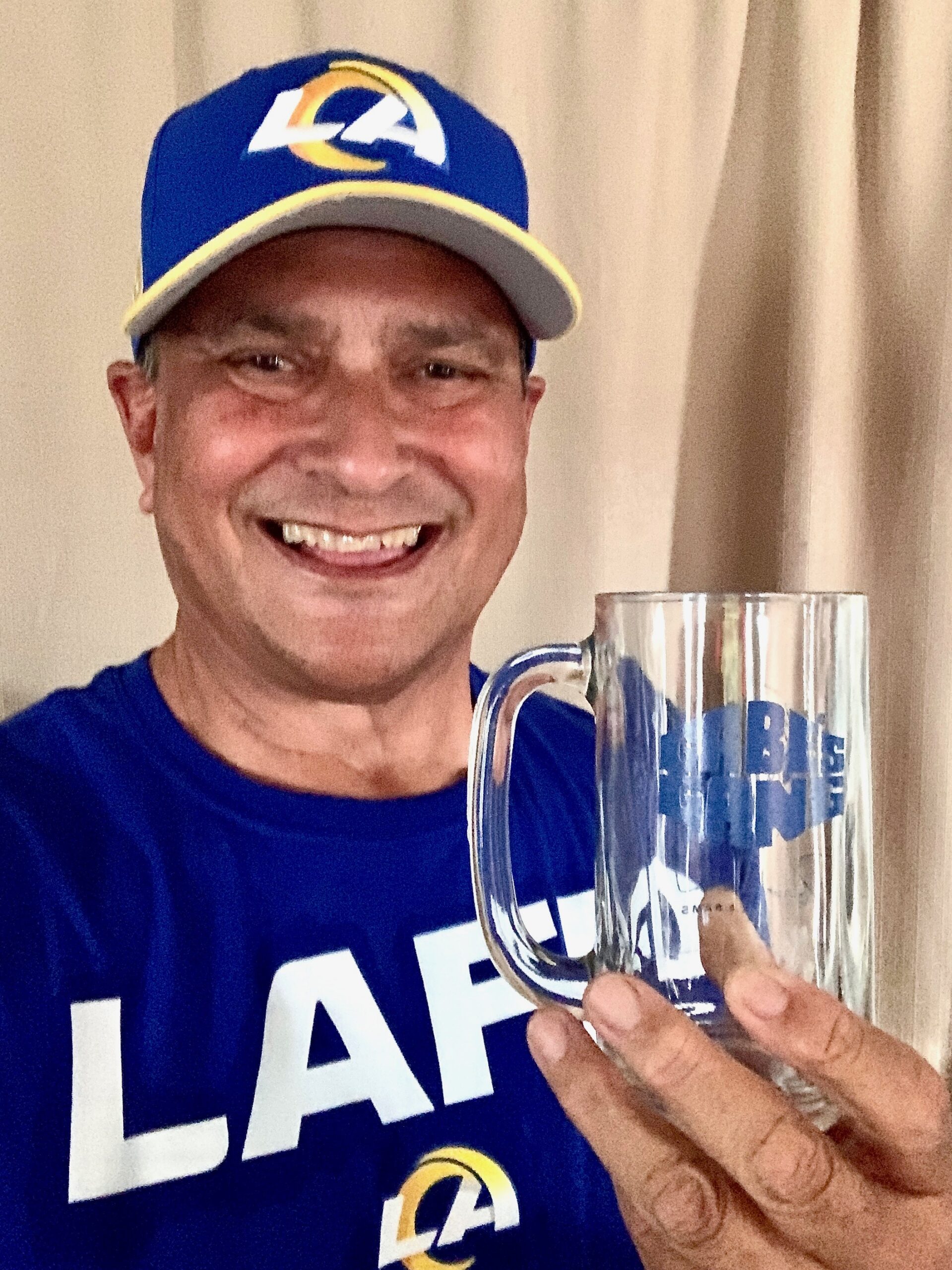 Rodney Yap fell in love with the Los Angeles Rams when he attended a Rams camp in 1972. Here he shows off his autographed Roman Gabriel mug that he got at that camp. Courtesy photo