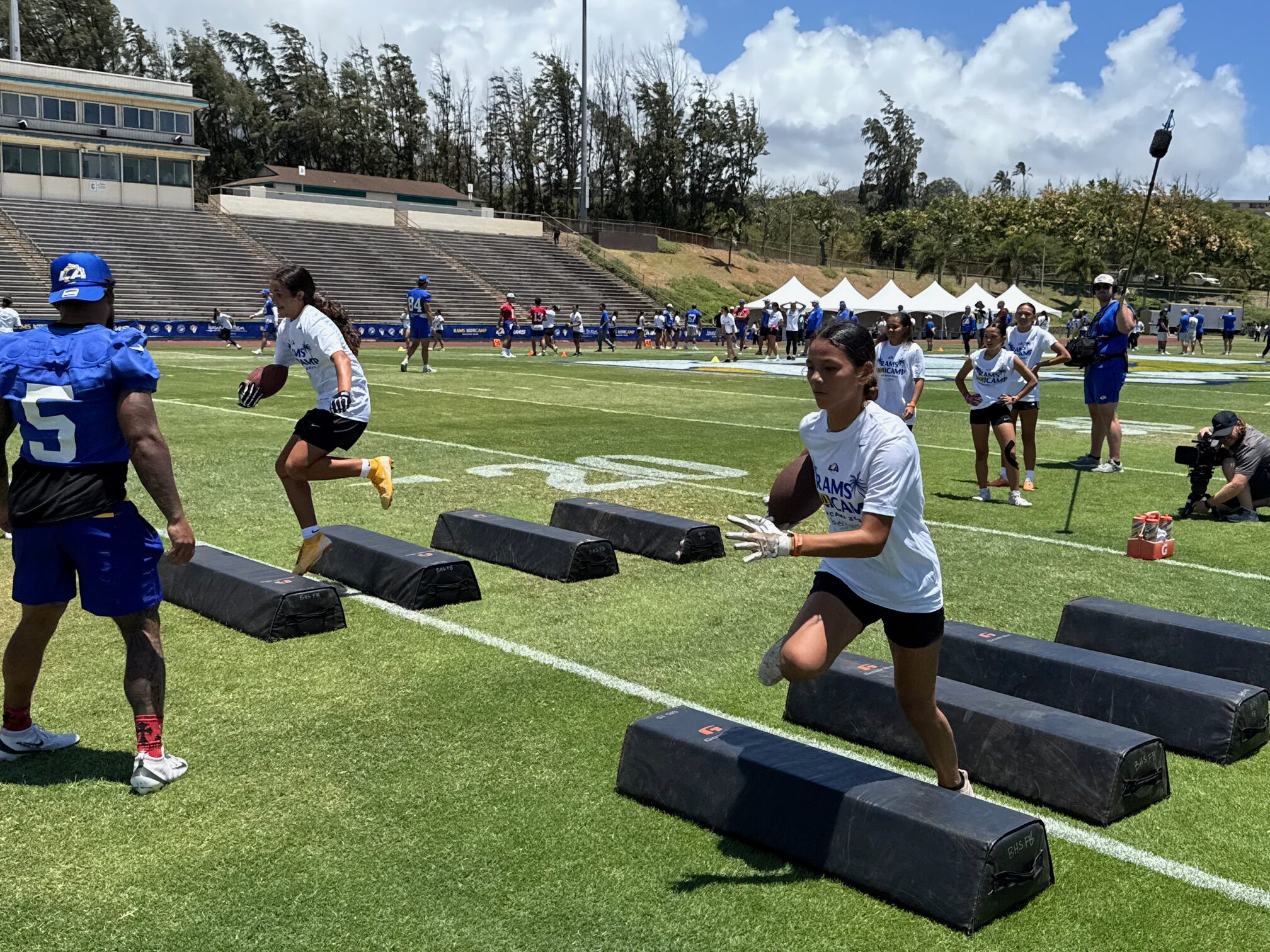 Tehana Rodrigues (left) runs an agility drill on Tuesday at the Los Angeles Rams' 'Mauicamp' on Tuesday as Kyren Williams (5) looks on. HJI / ROB COLLIAS photo