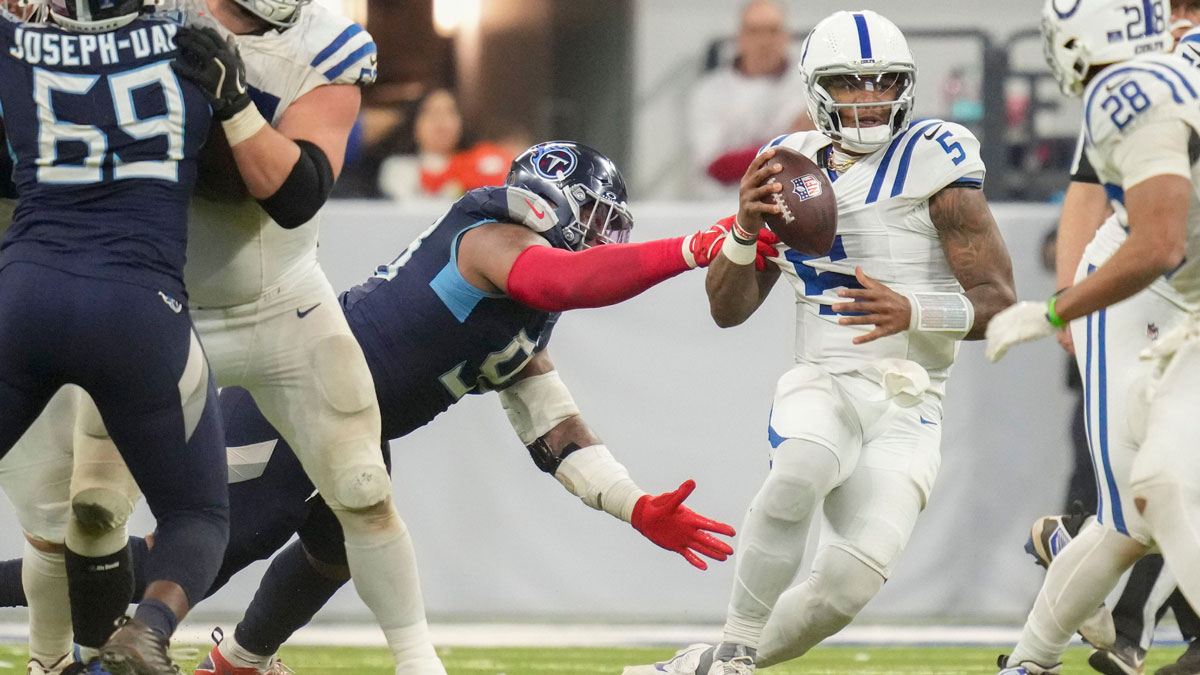 Indianapolis Colts quarterback Anthony Richardson (5) is sacked by Tennessee Titans defensive tackle Jeffery Simmons (98) on Sunday, Dec. 22, 2024, during a game against the Tennessee Titans at Lucas Oil Stadium in Indianapolis.
