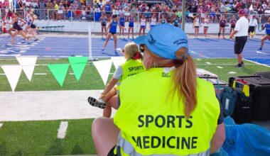 Sports medicine provider sitting on sidelines