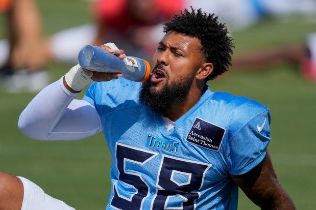 Tennessee Titans outside linebacker Harold Landry takes a drink of water during an NFL joint training camp practice with the Seattle Seahawks, Thursday, Aug. 15, 2024, in Nashville, Tenn. (AP Photo/George Walker IV)