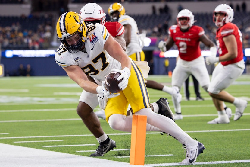 California tight end Jack Endries, left, is stopped short of the goal line by UNLV defensive...