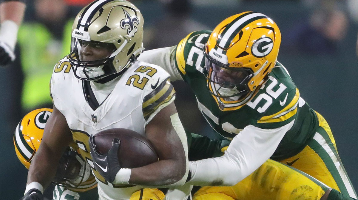 Green Bay Packers defensive end Rashan Gary (52) and linebacker Edgerrin Cooper (56) tackle New Orleans Saints running back Kendre Miller (25) on Monday, December 23, 2024 at Lambeau Field in Green Bay, Wis. The Packers defeated the Saints 34-0.