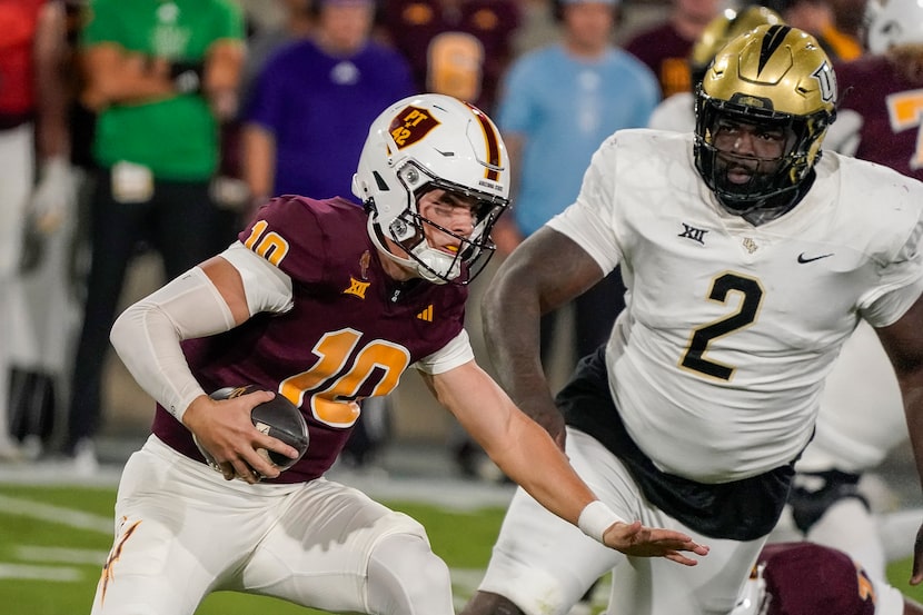 Arizona State quarterback Sam Leavitt (10) runs away from Central Florida defensive tackle...