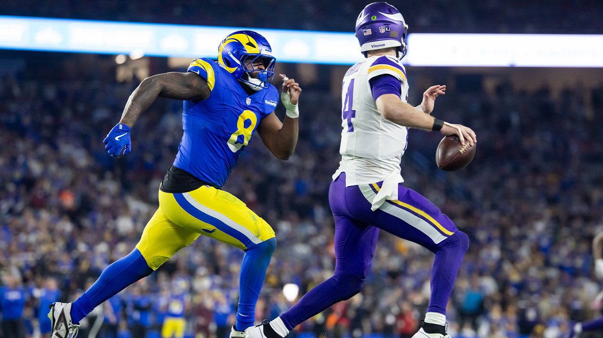 Minnesota Vikings quarterback Sam Darnold (14) is pursued by Los Angeles Rams linebacker Jared Verse (8) during an NFC wild card game at State Farm Stadium. Mandatory Credit: Mark J. Rebilas-Imagn Images