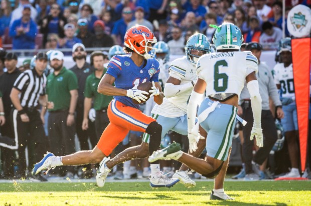 Florida Gators wide receiver Aidan Mizell (11) runs the ball after the catch against the Tulane Green Wave in the Gasparilla Bowl Dec. 20, 2024 at Raymond James Stadium in Tampa. (Willie J. Allen Jr./Orlando Sentinel)