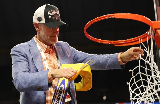 Florida athletic director Scott Stricklin cuts down the net after winning the NCAA Basketball National Championship Game of Florida vs. Houston at the Alamodome in San Antonio on Monday, April 7, 2025. Florida won the game 65-63. (Stephen M. Dowell/Orlando Sentinel)