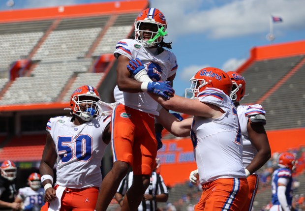 UF freshman receiver Dallas Wilson (No. 6) celebrates a touchdown with his teammates Mark Faircloth (right) and Jason Zandamela (No. 50) during the Orange and Blue spring game April 12 at Ben Hill Griffin Stadium in Gainesville. (UAA Communications/Victoria Riccobono)