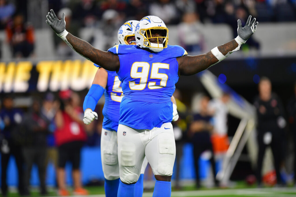 Los Angeles Chargers defensive tackle Poona Ford (95) reacts after sacking Cincinnati Bengals quarterback Joe Burrow (9) during the first half at SoFi Stadium.