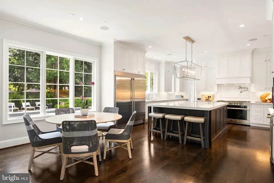 The chef’s kitchen overlooks the living room and features an all-white theme with a marble island and state-of-the-art appliances. <p class="credit">(Realtor.com)</p>