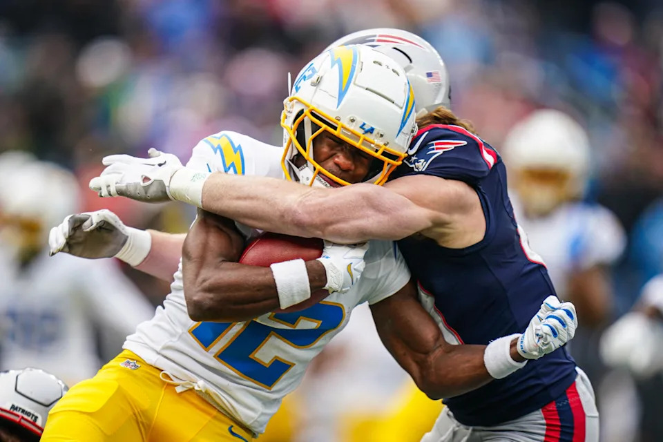 Los Angeles Chargers wide receiver Derius Davis (12) returns the ball against New England Patriots safety Brenden Schooler (41) in the first quarter at Gillette Stadium.David Butler II-Imagn Images
