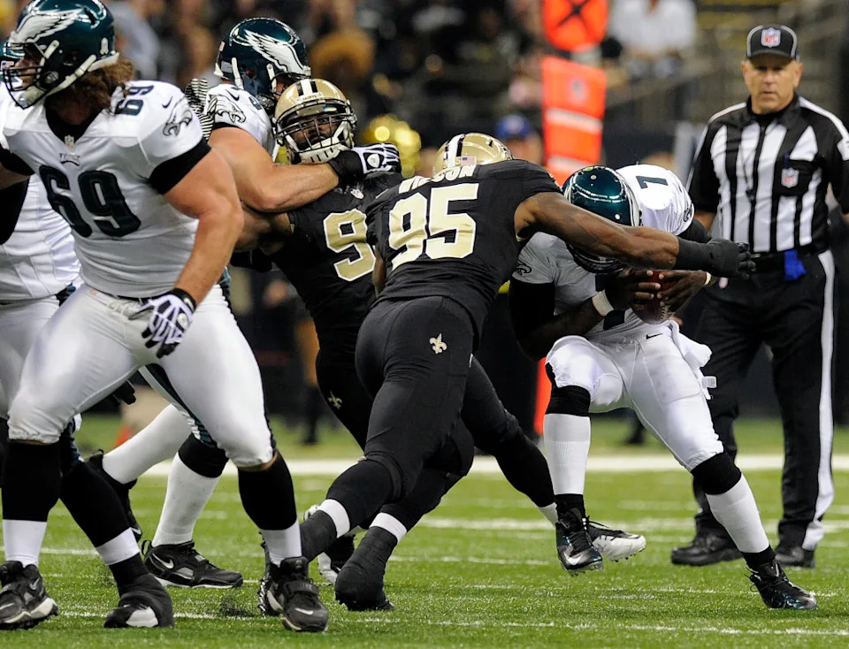 November 5, 2012; Philadelphia Eagles quarterback Michael Vick (7) gets sacked by New Orleans Saints defensive end Martez Wilson (95). Mandatory Credit: John David Mercer-Imagn Images