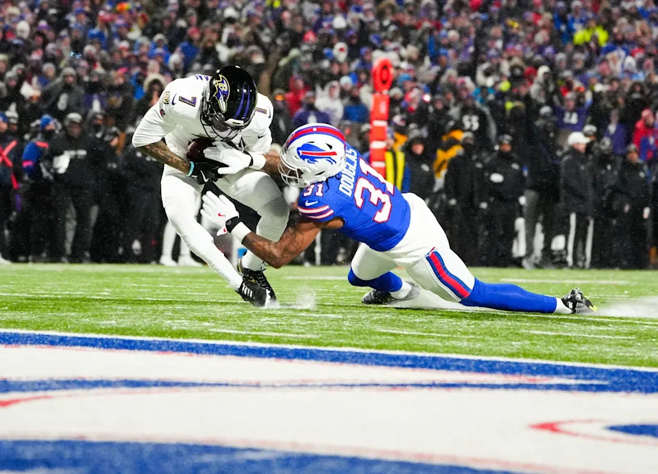 Jan 19, 2025; Orchard Park, New York, USA; Baltimore Ravens wide receiver Rashod Bateman (7) makes a catch against Buffalo Bills cornerback Rasul Douglas (31) during the second quarter in a 2025 AFC divisional round game at Highmark Stadium. Mandatory Credit: Gregory Fisher-Imagn Images