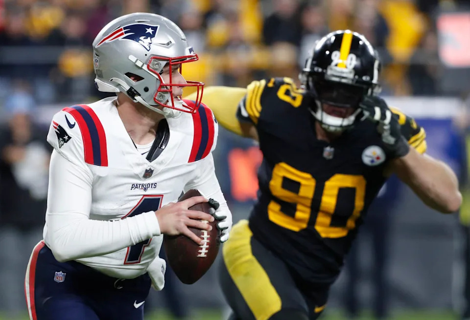 New England Patriots quarterback Bailey Zappe (4) runs the ball as Pittsburgh Steelers linebacker T.J. Watt (90) chases during the third quarter at Acrisure Stadium. New England won 21-18.Charles LeClaire-Imagn Images